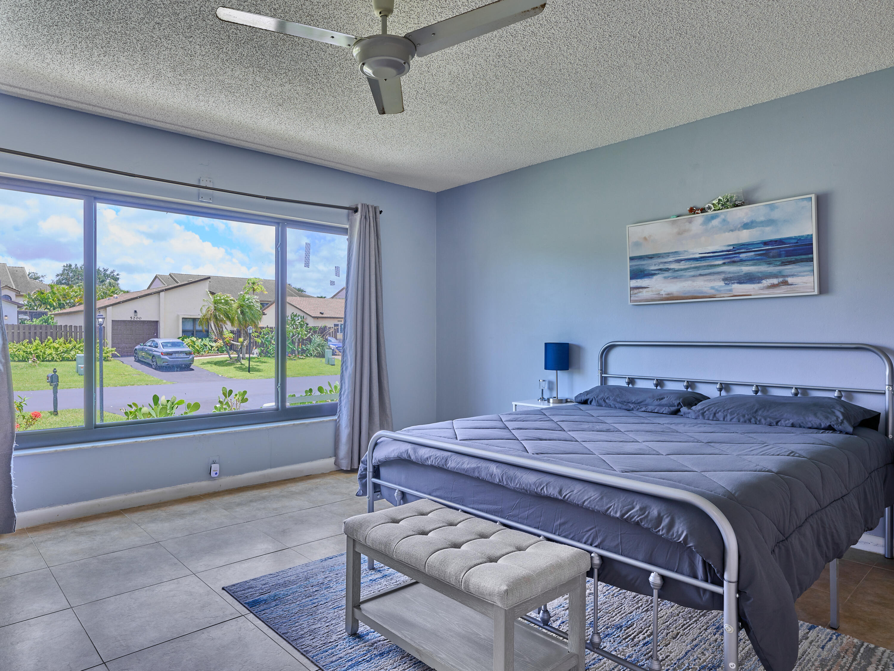 5197 Minto Road Boynton Beach, FL 33472 - Photo 14 of 32 a bedroom with a bed and a large window