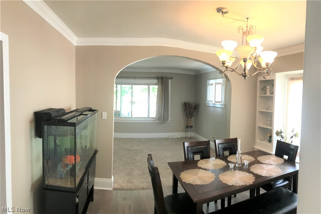 1387 Irene Road Lyndhurst, OH 44124 - Photo 5 of 14 Dining room view into living room, newer flooring, built-in china cabinets and window seat. Fish tank does not stay