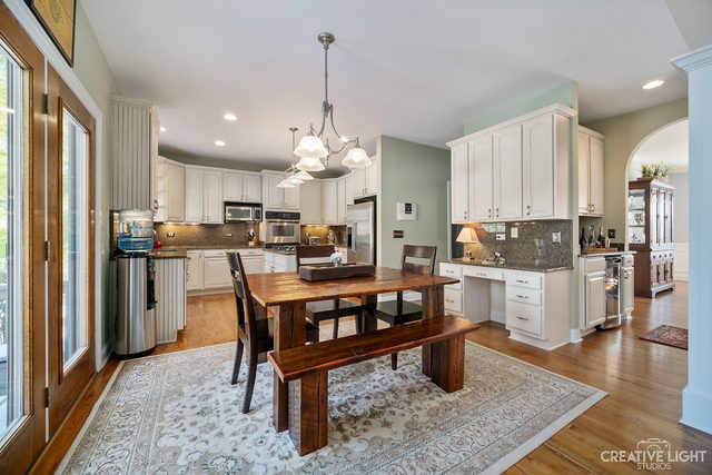8 Winthrop New Road Sugar Grove, IL 60554 - Photo 13 of 38 a kitchen with stainless steel appliances granite countertop a refrigerator a stove a sink dishwasher and white cabinets with wooden floor