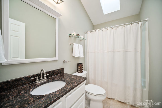 8 Winthrop New Road Sugar Grove, IL 60554 - Photo 22 of 38 a bathroom with a granite countertop sink and a mirror with toilet