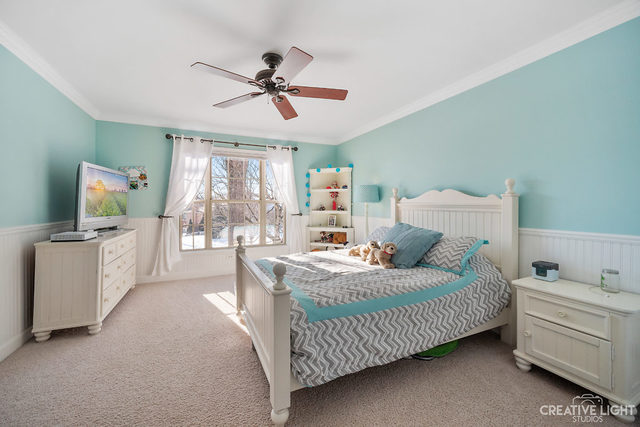 8 Winthrop New Road Sugar Grove, IL 60554 - Photo 23 of 38 a bedroom with a bed and a chandelier