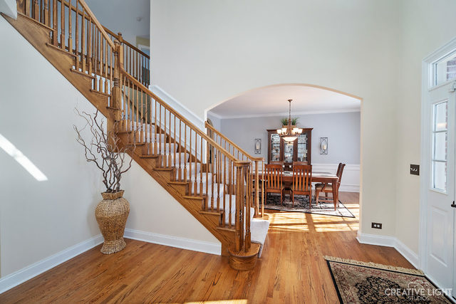 8 Winthrop New Road Sugar Grove, IL 60554 - Photo 4 of 38 a dining room with wooden floor and a chandelier