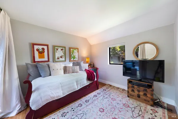 a bedroom with a bed a couch and dresser