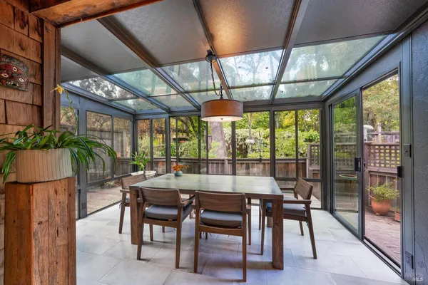 a dining room with furniture a chandelier and wooden floor