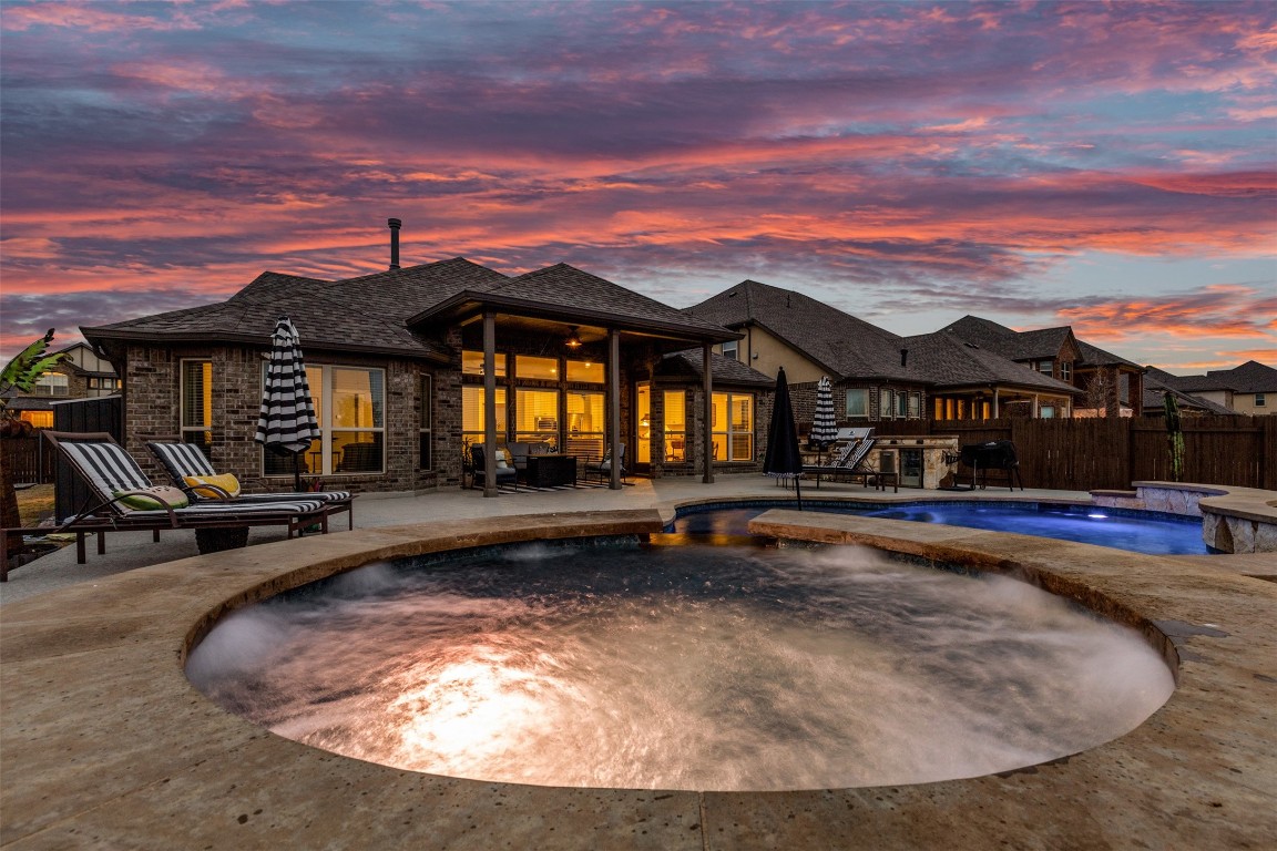 a view of a house with swimming pool and sitting area