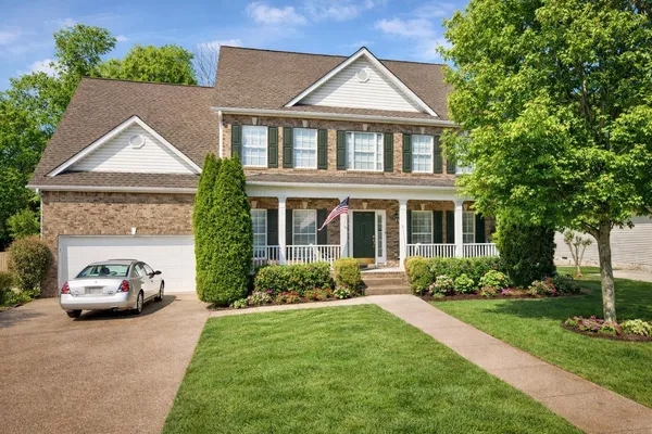 a front view of a house with a yard and garage