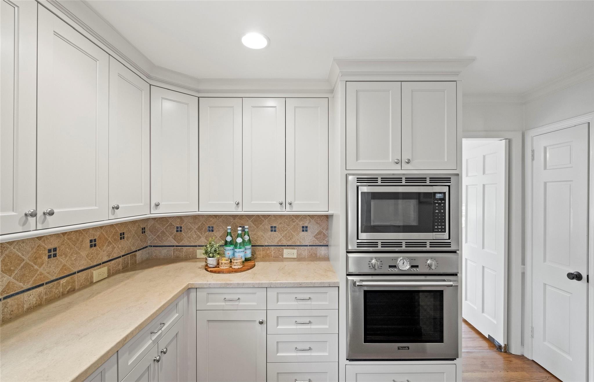 3136 Clarendon Road Charlotte, NC 28211 - Photo 13 of 47 a kitchen with granite countertop white cabinets and stainless steel appliances