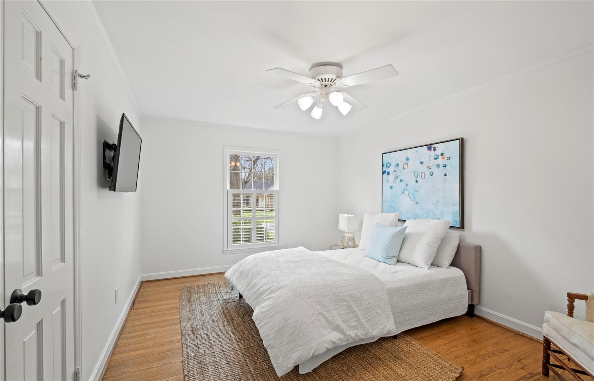 3136 Clarendon Road Charlotte, NC 28211 - Photo 22 of 47 a bedroom with a bed and a chandelier
