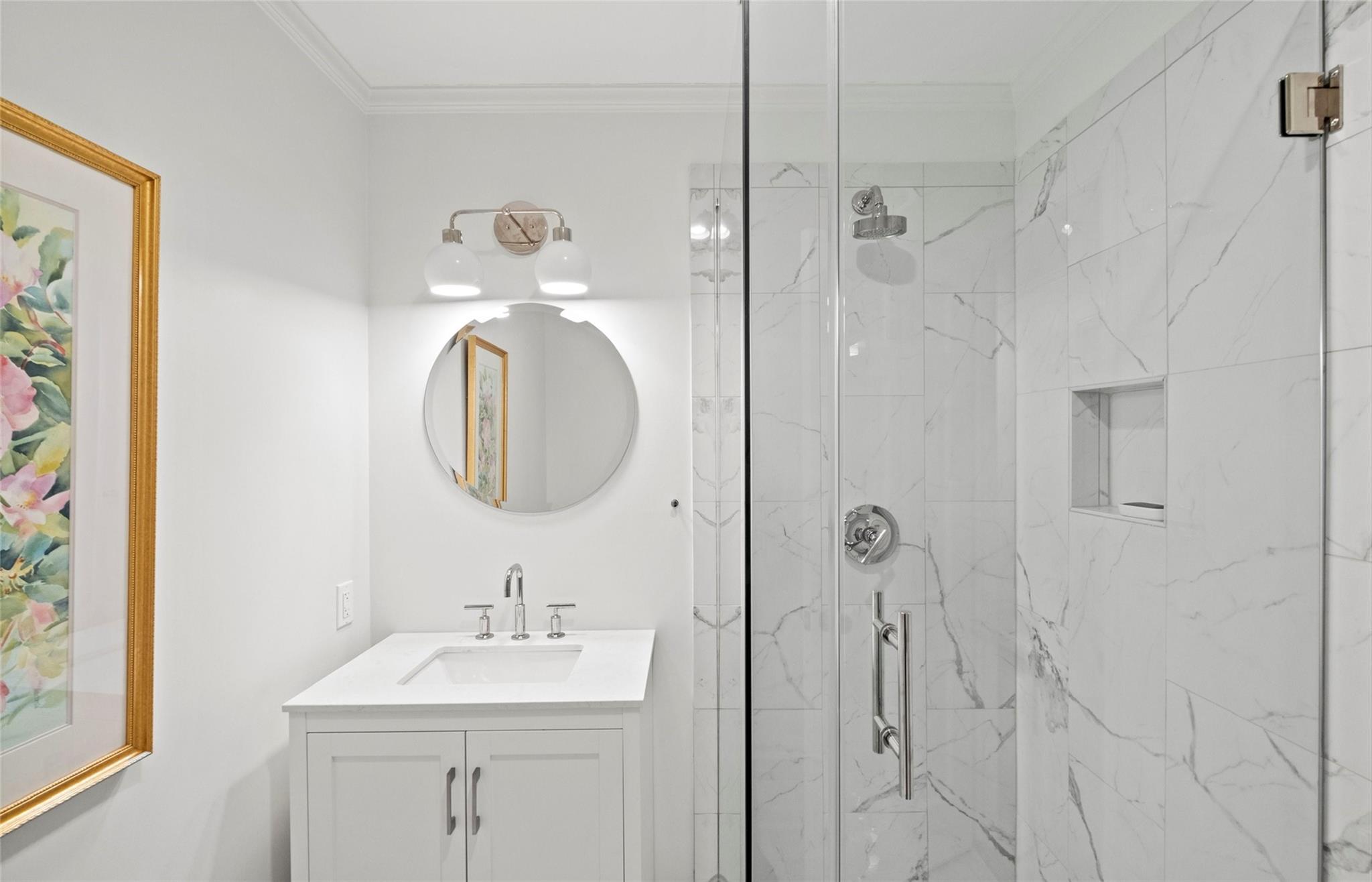 3136 Clarendon Road Charlotte, NC 28211 - Photo 24 of 47 a bathroom with a sink a mirror and a shower