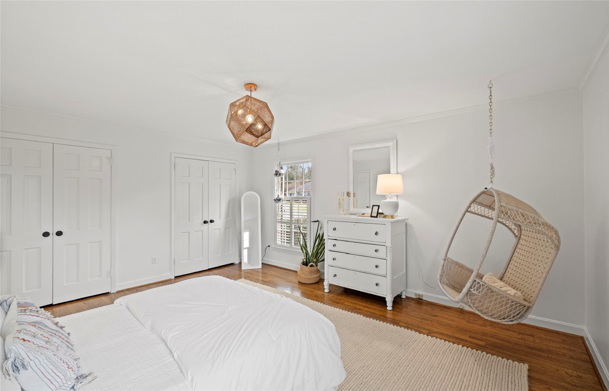 3136 Clarendon Road Charlotte, NC 28211 - Photo 29 of 47 a bedroom with a bed and a chandelier