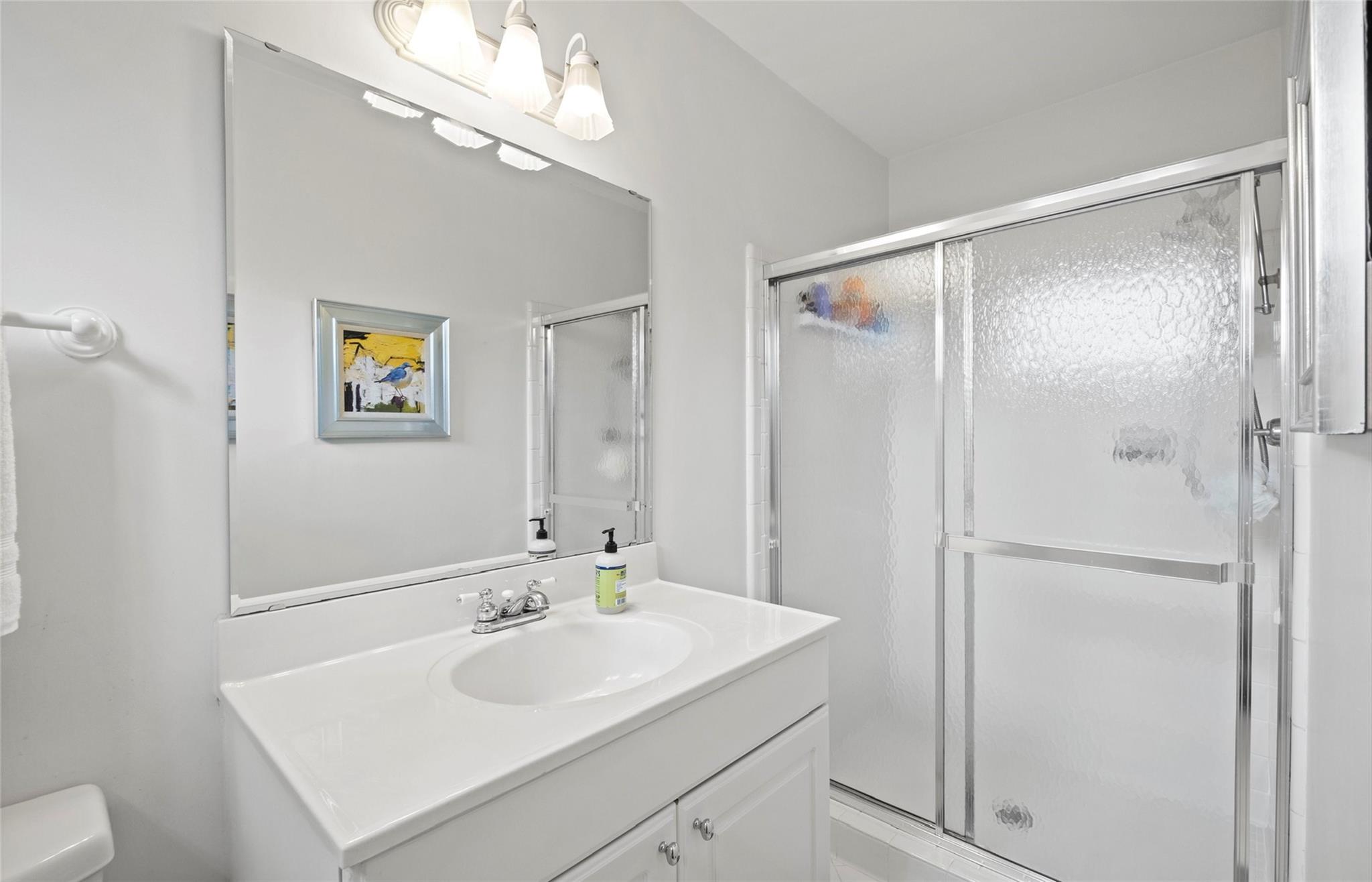 3136 Clarendon Road Charlotte, NC 28211 - Photo 30 of 47 a bathroom with a sink a mirror and a shower