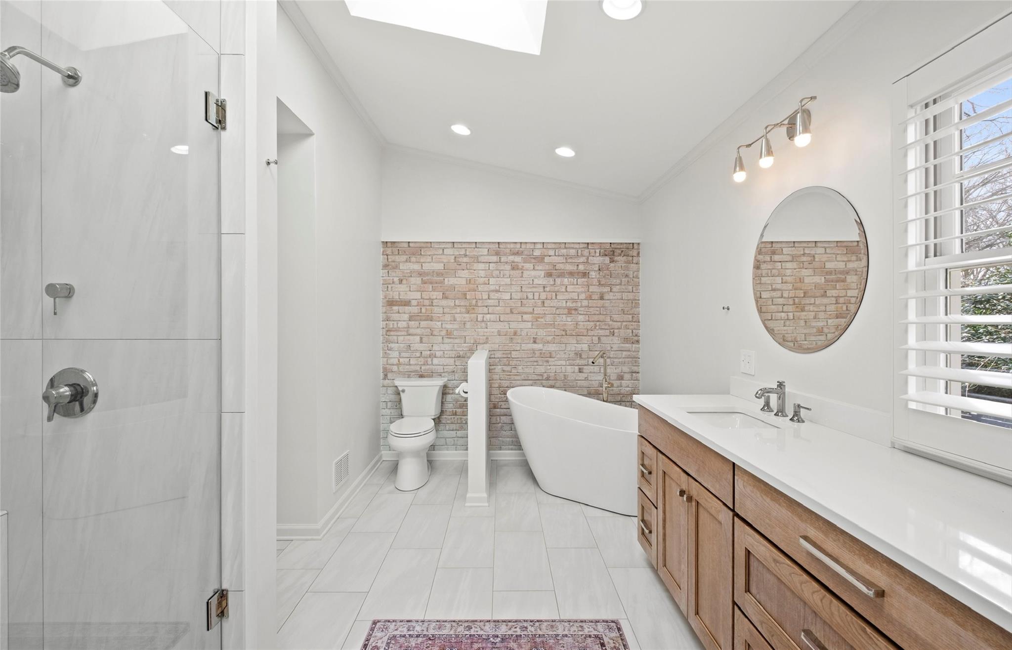 3136 Clarendon Road Charlotte, NC 28211 - Photo 37 of 47 a bathroom with a sink a toilet and shower