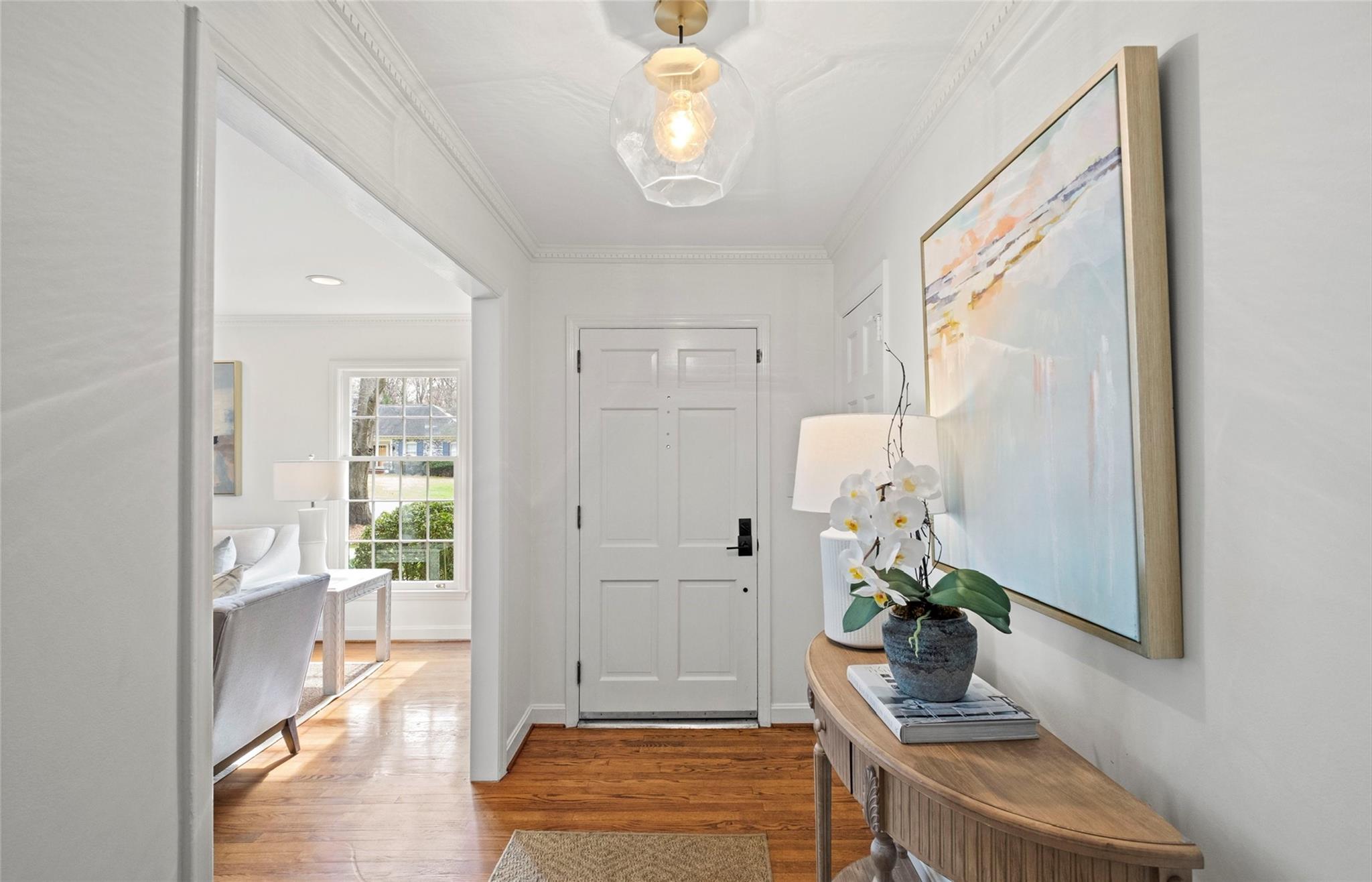 3136 Clarendon Road Charlotte, NC 28211 - Photo 4 of 47 a hallway with a dining table and chairs