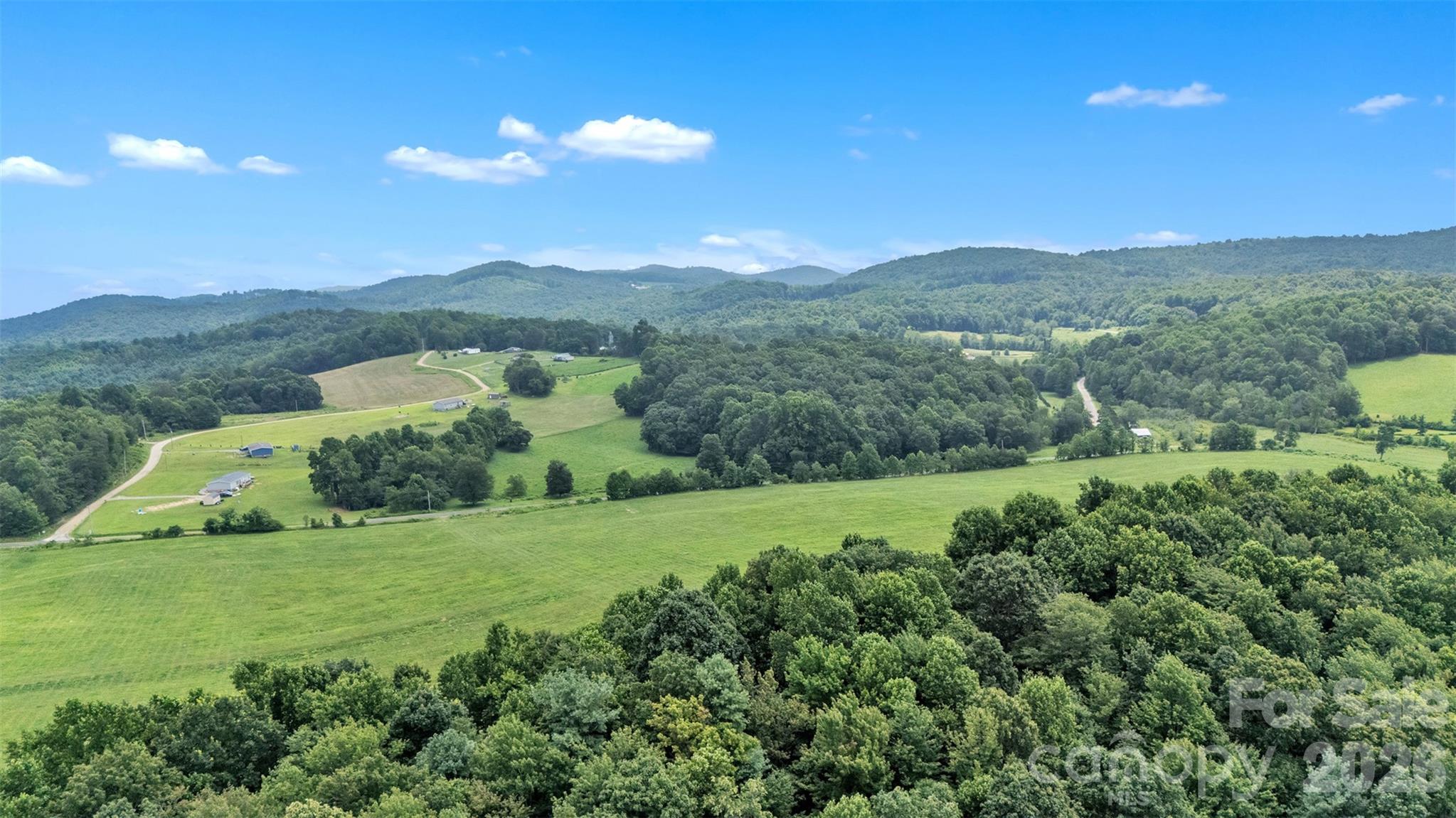 0 Pike Road Moravian Falls, NC 28654 - Photo 19 of 19 a view of a lush green outdoor space with a swimming pool and valleys in the background
