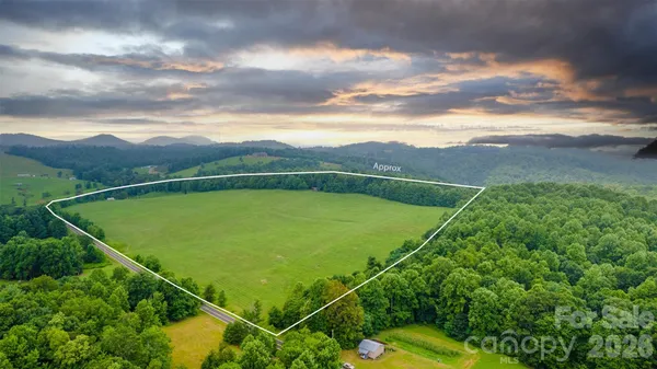 a view of a field with mountains in the background
