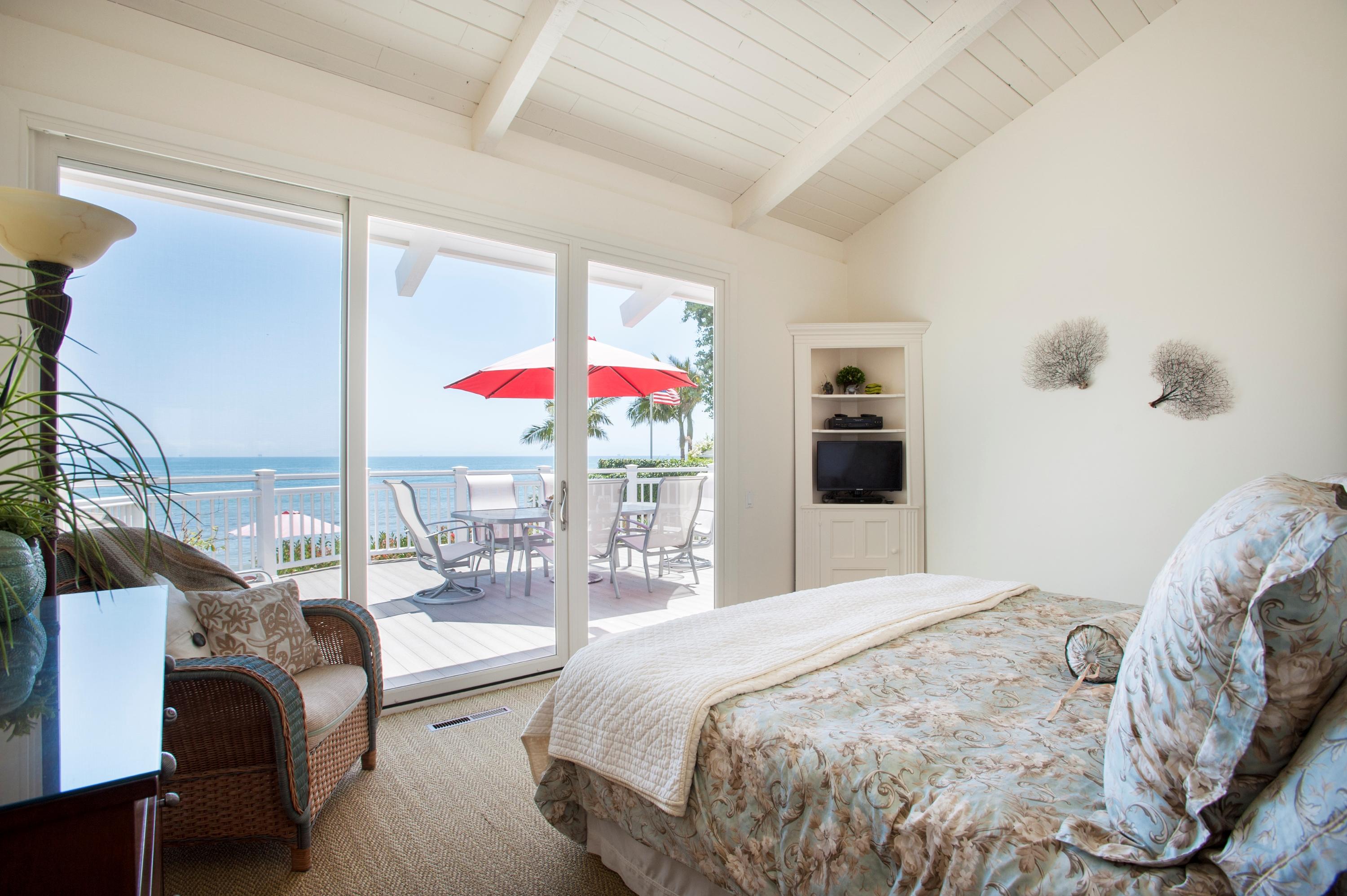 3284 Beach Club Road Carpinteria, CA 93013 - Photo 10 of 17 a bedroom with a bed and large windows