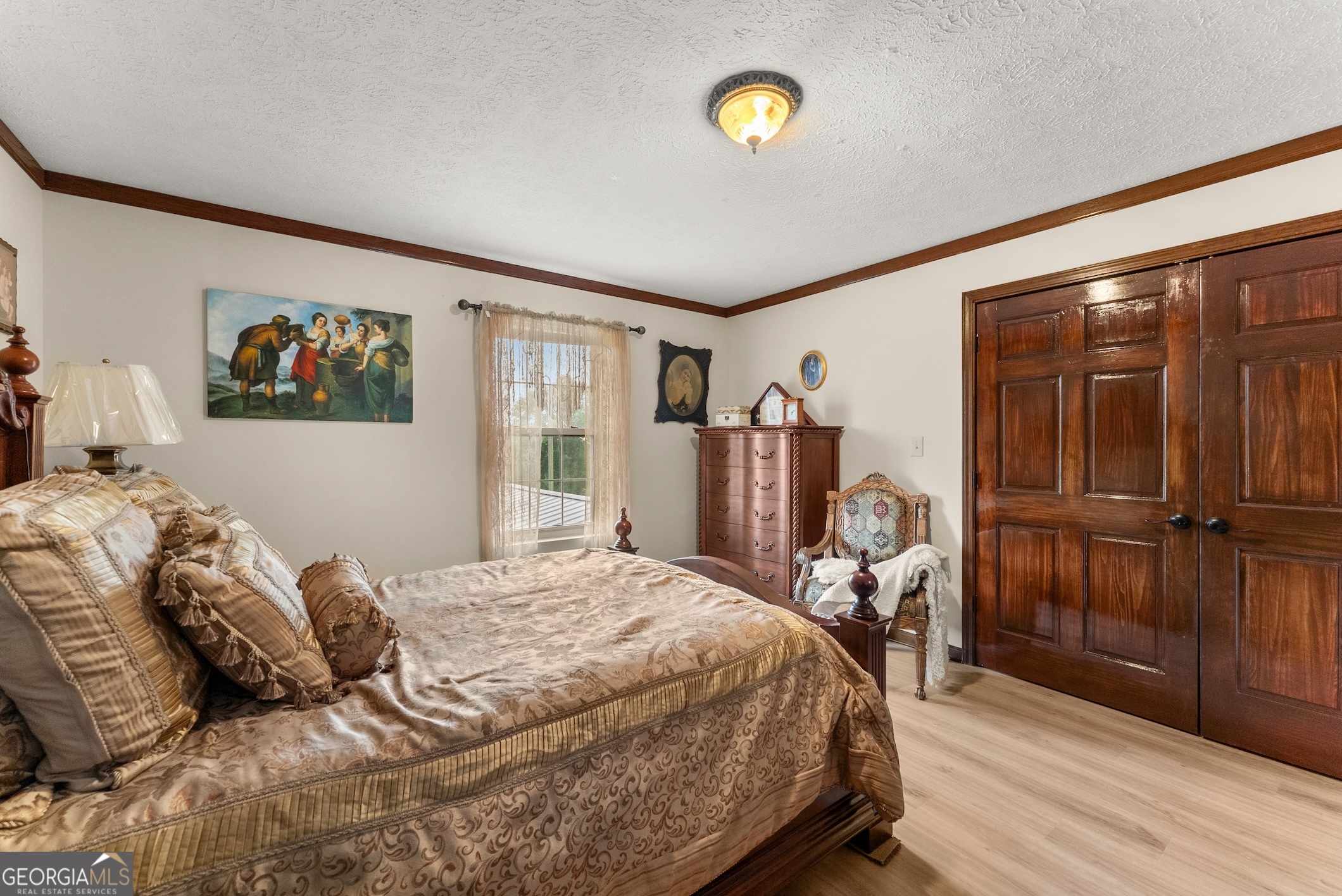 7215 Kelly Bridge Road Dawsonville, GA 30534 - Photo 28 of 81 a bedroom with a bed and wooden floor
