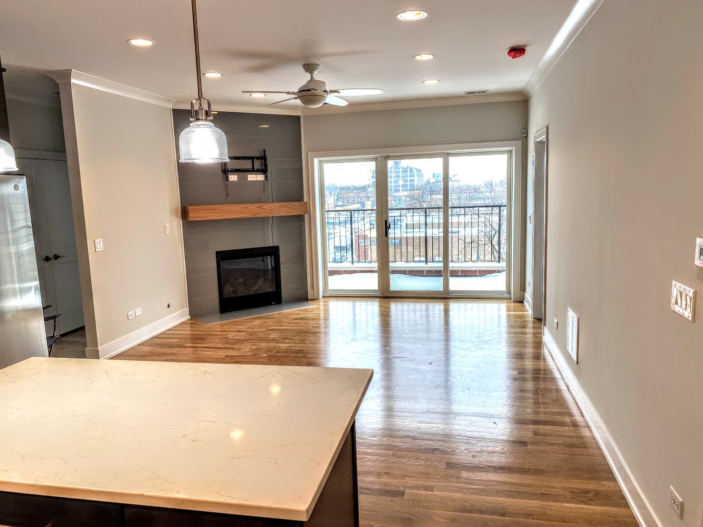 3203 North Ridgeway Avenue, Unit 2B Chicago, IL 60618 - Photo 6 of 15 a view of a room with wooden floor and fireplace