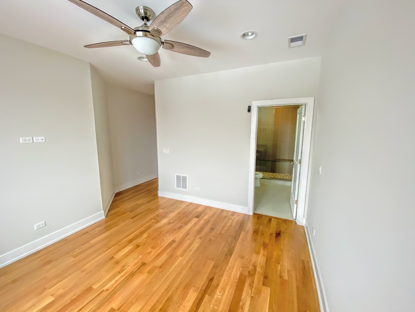 3203 North Ridgeway Avenue, Unit 2B Chicago, IL 60618 - Photo 7 of 15 a view of a big room with wooden floor and a ceiling fan