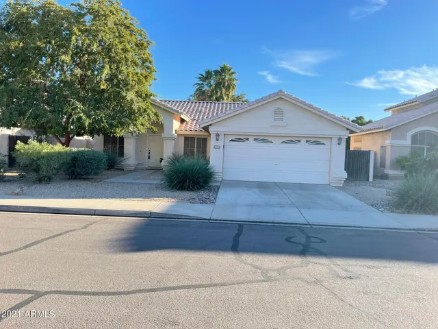 a front view of a house with plants