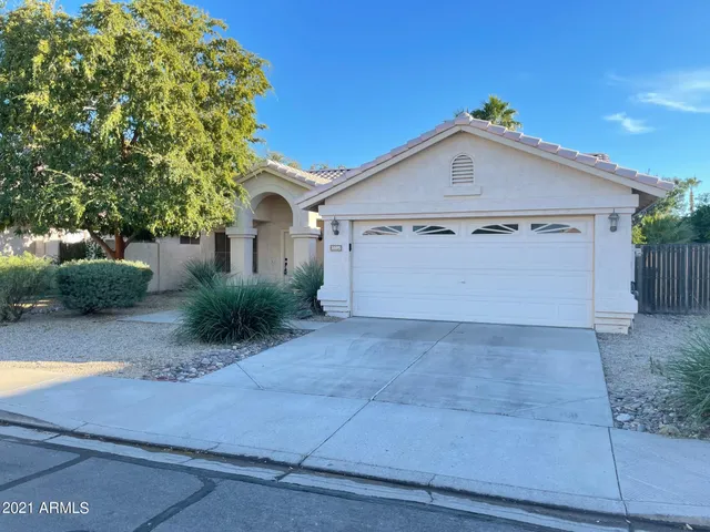 a view of a house with a yard and garage