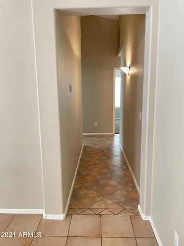 a view of a hallway with wooden shelves