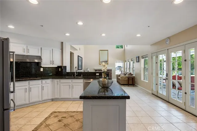 a kitchen with sink stove and cabinets