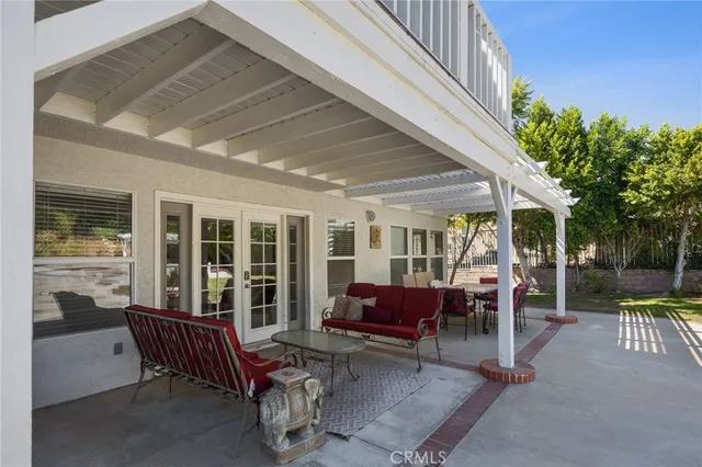 a view of a patio with couches chairs and potted plants