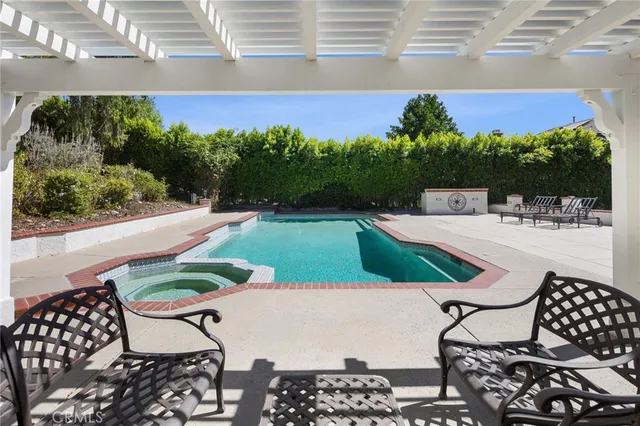 a view of a backyard with swimming pool