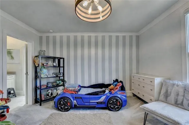 a view of a tall building and couple of cars parked in front of it