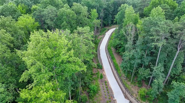 a street view with tall buildings and cars parked on road