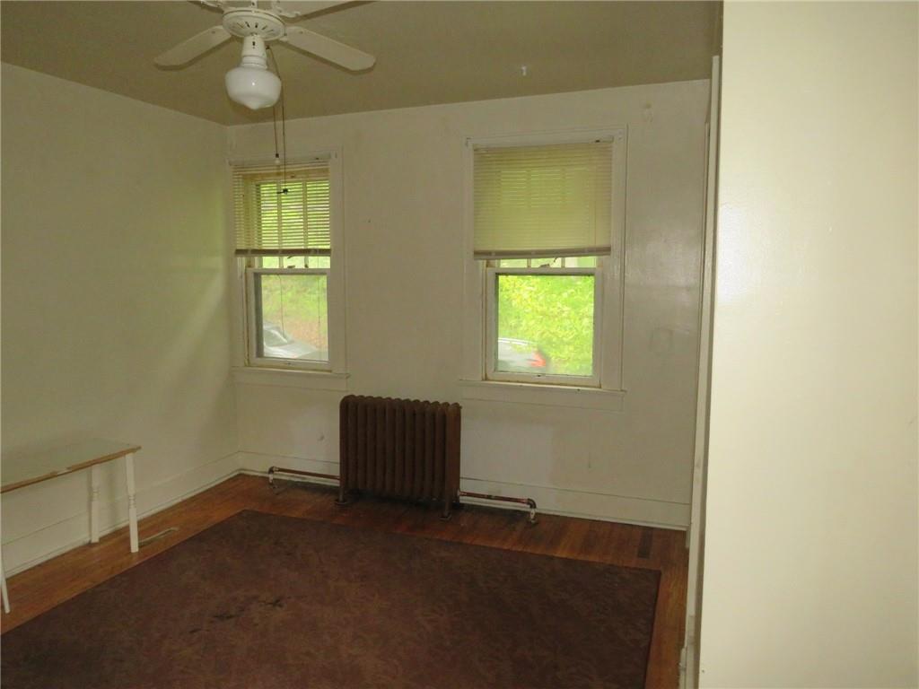 423 Braddock Road Pittsburgh, PA 15221 - Photo 20 of 36 an empty room with a window and chandelier fan