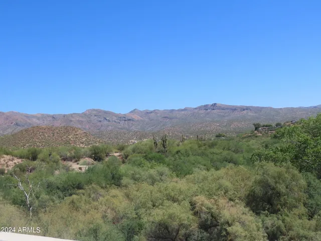 a view of a mountain range with trees in the background