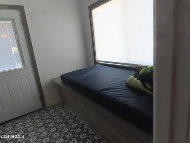 a bedroom with a bed and a window
