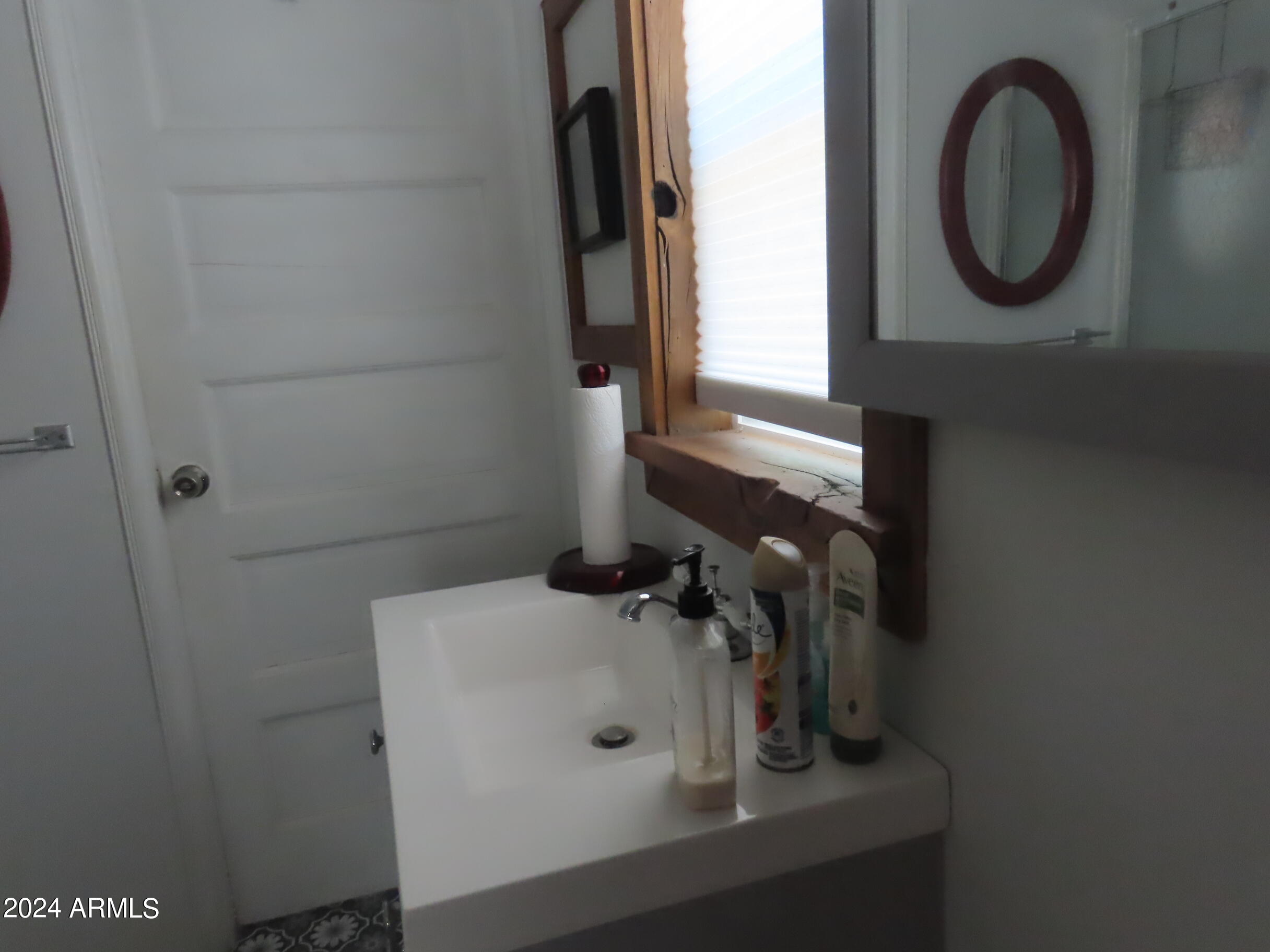 56120 East Riverside Road Kearny, AZ 85137 - Photo 10 of 28 a bathroom with a sink and a mirror