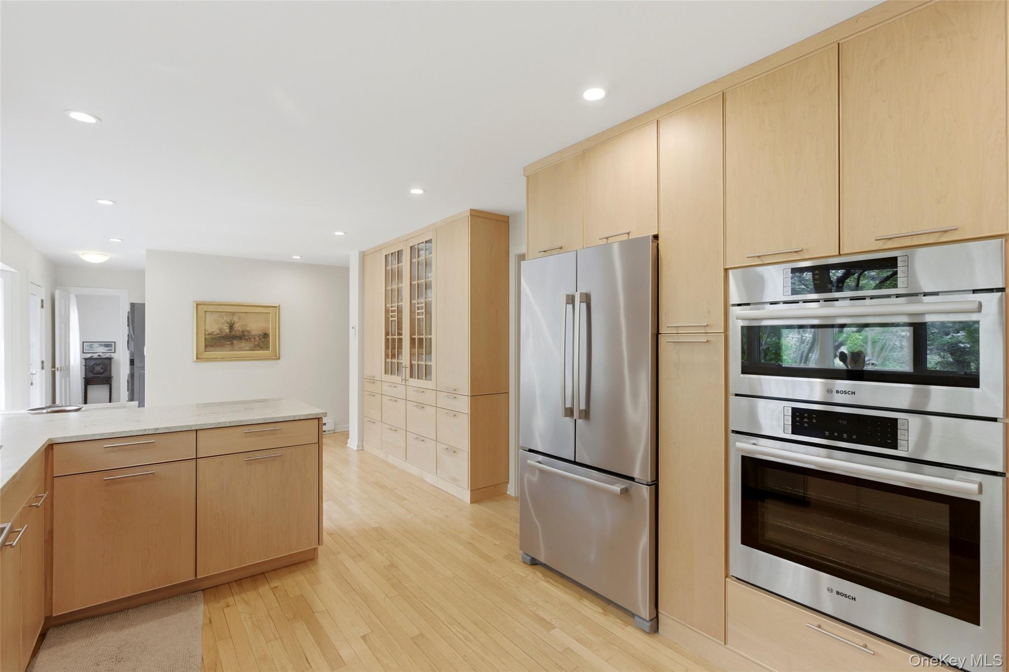 7 Gun Path Setauket, NY 11733 - Photo 15 of 34 a kitchen with stainless steel appliances white cabinets and wooden floor