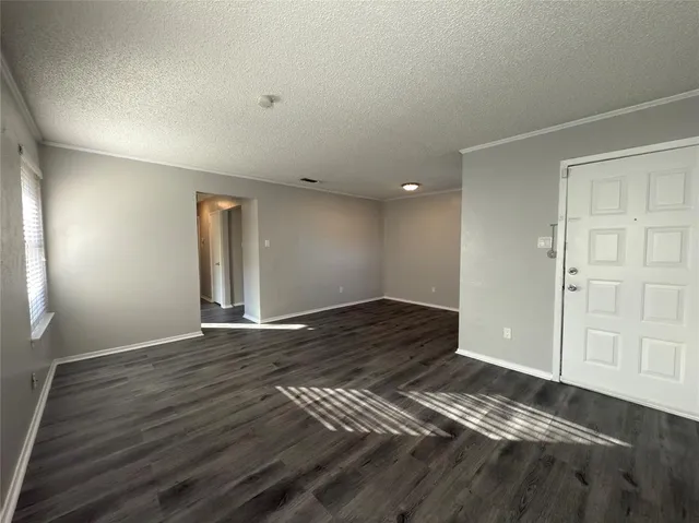 a view of an empty room and wooden floor
