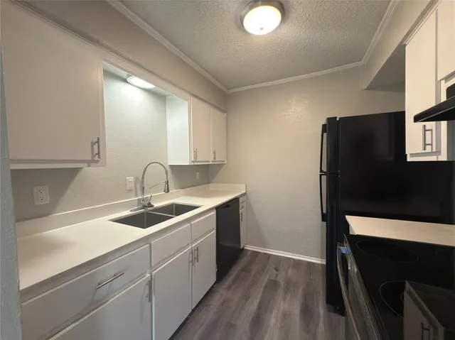 a kitchen with a sink and refrigerator