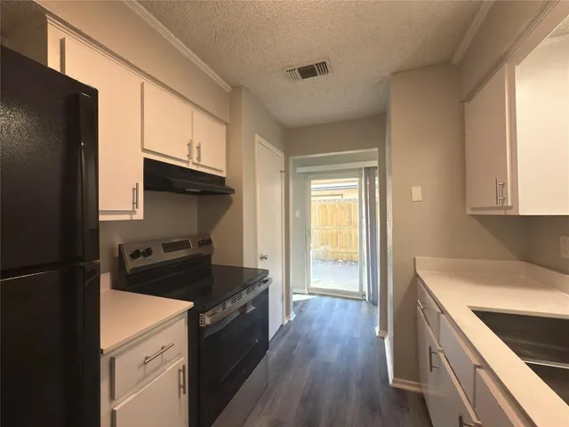a kitchen with a refrigerator stove and sink