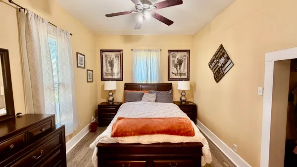 a bed room with a bed and a chandelier