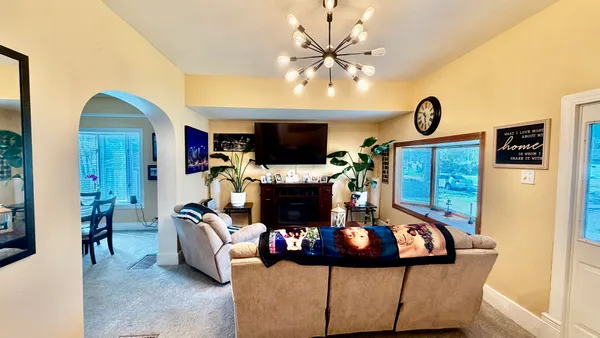 a living room with furniture a fireplace and a flat screen tv