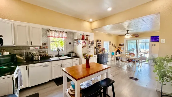 a kitchen with lots of counter top space and dining table