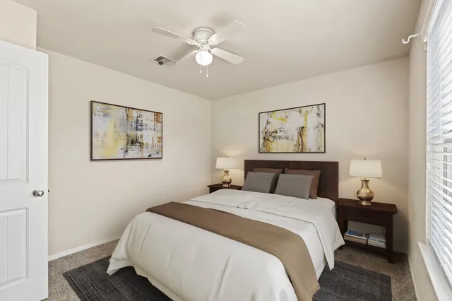 a bedroom with a large bed and a chandelier