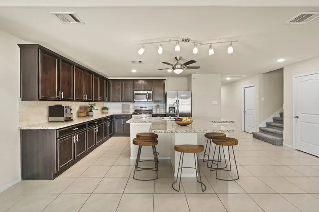 a kitchen with stainless steel appliances granite countertop a sink and cabinets