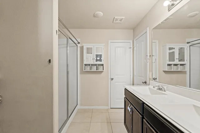 a bedroom with a bed a couch and a flat screen tv