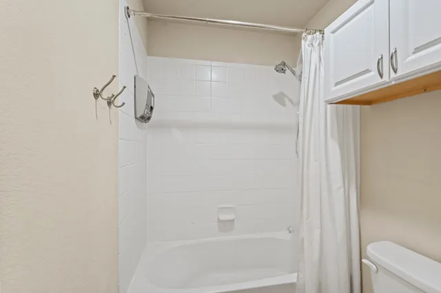 a bathroom with a double vanity sink a mirror and a bathtub