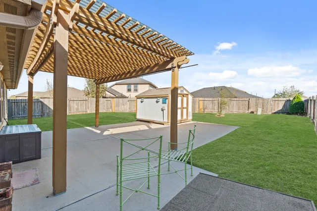 a spacious bedroom with a couch and wooden fence