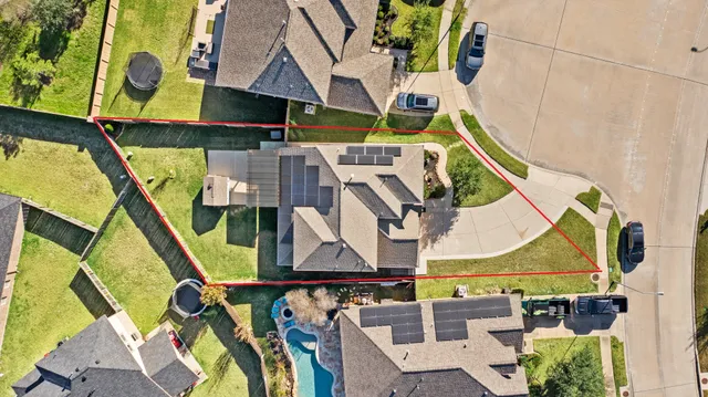 an aerial view of a house with a swimming pool