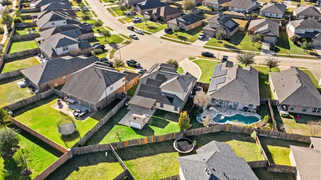 an aerial view of residential house with outdoor space and swimming pool