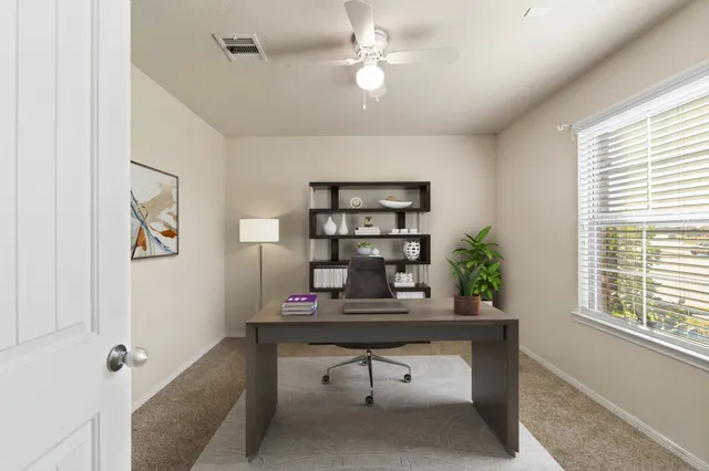 a view of a workspace with furniture